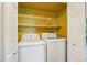 Laundry room features a washer and dryer and a shelf at 1310 S Monaco Pkwy # 23, Denver, CO 80224