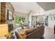 Bright living room with fireplace, large windows offering beautiful view, and comfortable seating arrangement at 1310 S Monaco Pkwy # 23, Denver, CO 80224