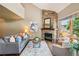 Comfortable living room with a stone fireplace, large window with natural light, and neutral-toned furniture at 1310 S Monaco Pkwy # 23, Denver, CO 80224