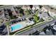 Aerial view of a community featuring a sparkling blue pool, playground, and open green spaces perfect for outdoor activities at 23560 Alamo Pl # B, Aurora, CO 80016
