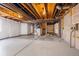 Spacious unfinished basement featuring exposed overhead beams, concrete floor, and stubbed for future customization at 23560 Alamo Pl # B, Aurora, CO 80016