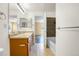 Bathroom with double sinks, tiled tub, and view into the bedroom at 23560 Alamo Pl # B, Aurora, CO 80016