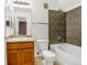 Bathroom featuring a single sink vanity, tiled shower, and toilet at 23560 Alamo Pl # B, Aurora, CO 80016