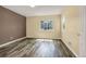 This is a bedroom with wood-look flooring and a window overlooking the neighborhood at 23560 Alamo Pl # B, Aurora, CO 80016