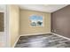 Bedroom with wood-look flooring and a large window, offering a bright and inviting space at 23560 Alamo Pl # B, Aurora, CO 80016