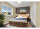 Bedroom featuring a wood-slatted bed frame, neutral walls, and a bright window at 23560 Alamo Pl # B, Aurora, CO 80016