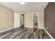 Bedroom featuring stylish wood-look floors and multiple doorways leading to various areas at 23560 Alamo Pl # B, Aurora, CO 80016