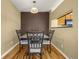 Cozy dining area with a modern table, neutral walls, and hardwood floors at 23560 Alamo Pl # B, Aurora, CO 80016