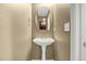 Clean powder room featuring a pedestal sink, neutral walls, and modern fixtures at 23560 Alamo Pl # B, Aurora, CO 80016