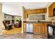 Kitchen area with stainless steel appliances, wood cabinets, and an open layout to living area at 23560 Alamo Pl # B, Aurora, CO 80016