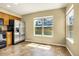 Well-lit kitchen with stainless steel appliances and view of neighborhood homes at 23560 Alamo Pl # B, Aurora, CO 80016