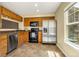 Functional kitchen featuring wood cabinets, stainless steel appliances, and ample counter space at 23560 Alamo Pl # B, Aurora, CO 80016
