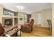 Inviting living room featuring a fireplace, hardwood floors, and an open layout at 23560 Alamo Pl # B, Aurora, CO 80016