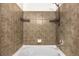 Tiled bathtub-shower combo with built-in shelves and modern fixtures at 23560 Alamo Pl # B, Aurora, CO 80016