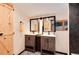 Bathroom featuring dual sink vanity and a stylish wood door at 21221 Colorado 103, Idaho Springs, CO 80452