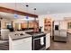 Kitchen featuring stainless steel appliances, breakfast bar and wood floors at 21221 Colorado 103, Idaho Springs, CO 80452