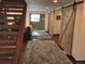Inviting living room featuring wood floors, a sliding barn door, and stairs at 21221 Colorado 103, Idaho Springs, CO 80452