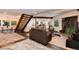 Cozy living room with stone fireplace, carpet, and wood staircase at 21221 Colorado 103, Idaho Springs, CO 80452
