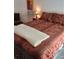 Main bedroom with a plush red bedspread, soft lighting, and cozy ambiance at 21221 Colorado 103, Idaho Springs, CO 80452