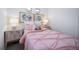 Charming bedroom with pink bedding and nightstands at 45032 Sunflower Ln, Bennett, CO 80102