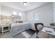 Bright bedroom with a queen bed, desk, and window coverings at 45032 Sunflower Ln, Bennett, CO 80102