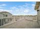 Private deck with white railing and view of the neighborhood at 45032 Sunflower Ln, Bennett, CO 80102