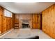 Finished basement with wood paneling, fireplace, and carpeted floors at 5700 E Floyd Ave, Denver, CO 80222