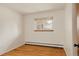 Bedroom featuring hardwood floors, window, and neutral walls at 5700 E Floyd Ave, Denver, CO 80222