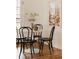 Cozy breakfast nook featuring a white table and black chairs next to a bright window at 5700 E Floyd Ave, Denver, CO 80222
