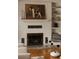 Stylish fireplace with white brick surround, mantel decor, and built-in shelving at 5700 E Floyd Ave, Denver, CO 80222