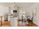 Bright and open kitchen with sleek white cabinetry and an eat-in breakfast nook at 5700 E Floyd Ave, Denver, CO 80222