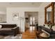 Cozy living room featuring hardwood floors and a seamless transition to the kitchen at 5700 E Floyd Ave, Denver, CO 80222