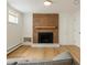 Bright and airy living room features a brick fireplace and custom built-ins at 5700 E Floyd Ave, Denver, CO 80222