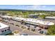 Aerial view of shopping center with ample parking and surrounding green spaces, and mountain views in the distance at 1232 Berganot Trl, Castle Pines, CO 80108