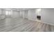 Spacious basement area with hard wood floors, recessed lighting, and access to an adjacent bathroom at 1232 Berganot Trl, Castle Pines, CO 80108