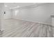 Spacious, unfinished basement with light gray walls and modern hardwood floors, and an egress window at 1232 Berganot Trl, Castle Pines, CO 80108