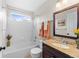 Well-lit bathroom with a shower and tub combination and a modern vanity featuring a granite countertop at 1232 Berganot Trl, Castle Pines, CO 80108