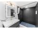 Modern bathroom boasts black textured tile on the shower walls with a stone tiled shower floor at 1232 Berganot Trl, Castle Pines, CO 80108