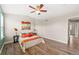 Comfortable bedroom boasts a ceiling fan and hardwood floors, plus bright orange, blue, and white color scheme at 1232 Berganot Trl, Castle Pines, CO 80108