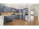 Updated kitchen with stainless appliances, stylish countertops, and dark wood floors at 1232 Berganot Trl, Castle Pines, CO 80108