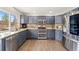 Updated kitchen featuring stainless steel appliances, granite counters, and hardwood flooring at 1232 Berganot Trl, Castle Pines, CO 80108