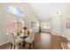 Bright living area shows hardwood floors, modern chandelier, and large windows at 1232 Berganot Trl, Castle Pines, CO 80108