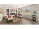 Bright living room with a cozy fireplace, large window, and hardwood floors offers a relaxing atmosphere at 1232 Berganot Trl, Castle Pines, CO 80108