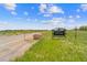 Entrance to Daniels Park with stone boulders, a sign, and views of the surrounding grassy landscape under a clear blue sky at 1232 Berganot Trl, Castle Pines, CO 80108