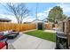 A backyard features artificial grass, patio area, BBQ grill and an outdoor seating area at 1402 Meade St, Denver, CO 80204