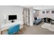 Finished basement area featuring a desk, retro gaming setup, and comfortable seating at 1402 Meade St, Denver, CO 80204