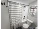 Modern bathroom featuring a shower-tub combo with black hardware and a stylish curtain at 1402 Meade St, Denver, CO 80204