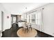Dining room with a modern table set, ample windows and view into the stylish kitchen at 1402 Meade St, Denver, CO 80204