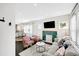 Bright living room with tiled fireplace, neutral sofa, and views into the modern kitchen at 1402 Meade St, Denver, CO 80204