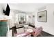 Bright living room with fireplace, and views into the kitchen and dining area at 1402 Meade St, Denver, CO 80204